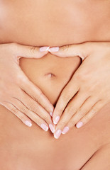 Hands on slim female belly