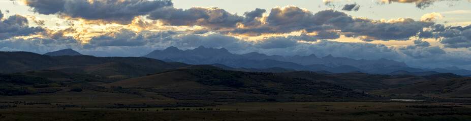 Orange sunset illuminating the mountains on the edge of the rockies