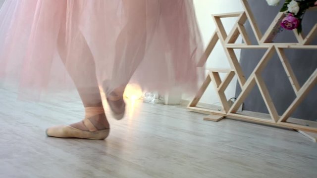 Close up of a ballet dancer's feet. Girl dancing in white room