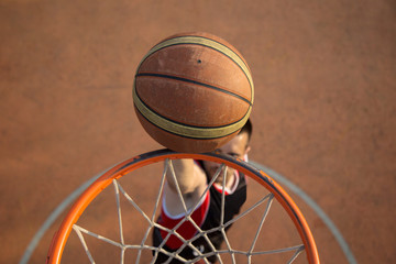 Basketball street player making a slam dunk