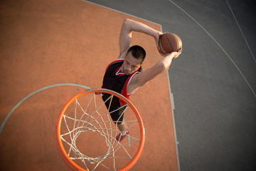 Basketball street player making a slam dunk © FS-Stock