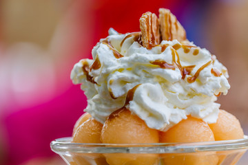 Fresh fruit salad with ice cream in a  melon cup
