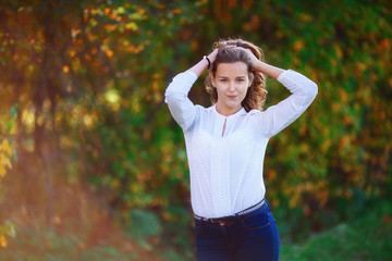 Young woman. Smiling pretty girl posing in colorful autumn park