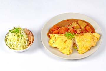 Omelet jasmine rice topped Japanese yellow curry  with sliced cabbage and pickled ginger isolated on white background.