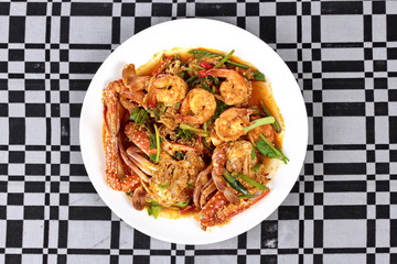 Stir-fried crab and shrimp in curry power is top-ten of popular Thai food as seafood to fried with  fresh milk ,grill curry ,egg ,oyster oil and yellow curry power. 