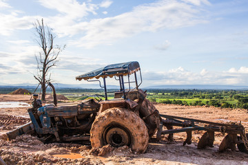 The image of the tractor in the mud