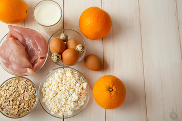 Chicken fillet, cottage cheese, eggs, yogurt, oranges and oat flakes
