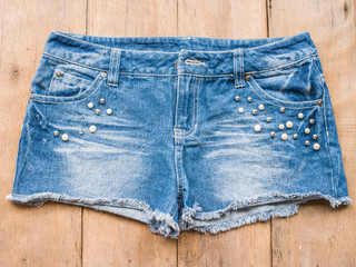 Short jean on wood background
