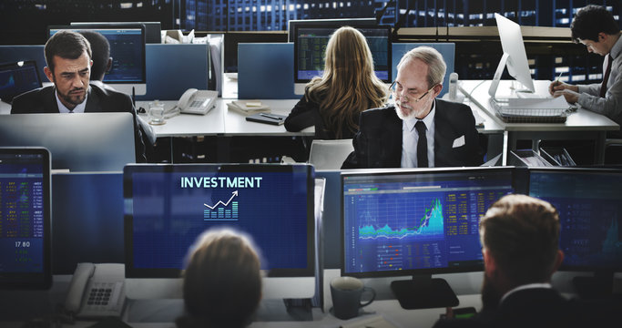 a group of people working on computers in an office - Invest Investment Financial Income Profit Cost