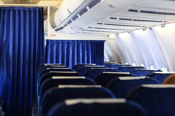 Seats and white panel inside airplane