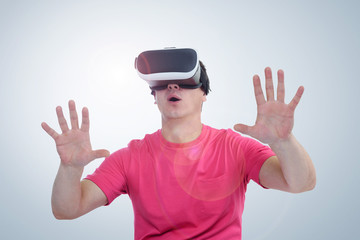 Man wearing virtual reality goggles. Surprise and delight