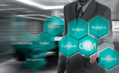 business, technology, internet and customer relationship management concept. Businessman pressing crm button on virtual screens