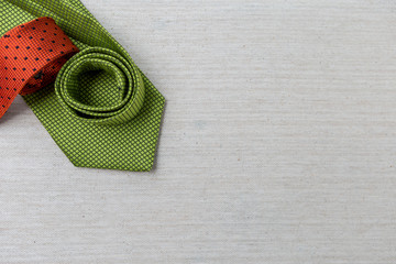 Design green and orange necktie on canvas background