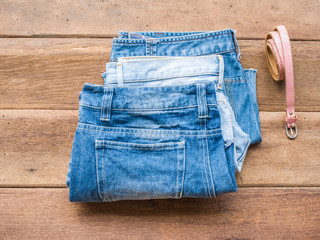 Short jean with pink belt on wood background

