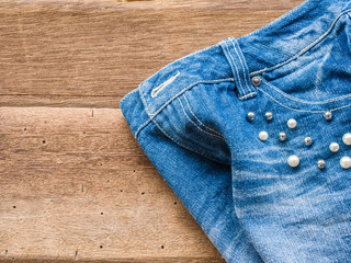 Short jean with belt on wood background
