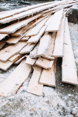 Bunch of boards covered with snow texture. Frosted wooden planks left outside in winter. Cold, early frosts, hoar concept