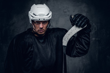 Portrait of hockey player with the gaming stick.