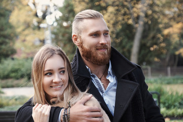Fototapeta premium Redhead bearded male hugging cute blonde female.