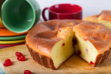 Home-made biscuit pie, red berries and cups