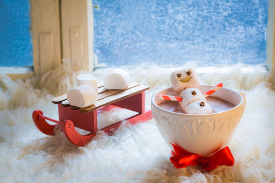 Sweet and happy snowman for Christmas in hot chocolate