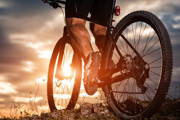 cyclist man legs riding mountain bike on outdoor trail