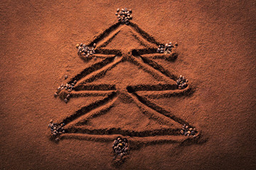 Christmas tree symbol drawn on the ground coffee with grains
