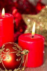 burning candles with Christmas ornaments