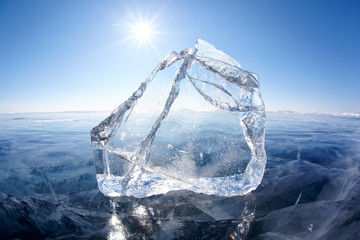 Ice floe and sun on winter Baikal lake