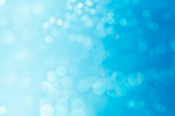 Bokeh soft pastel  blue and white background with blurred  lights. Festive background.