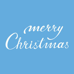 Calligraphic phrase Merry Christmas on blue background.