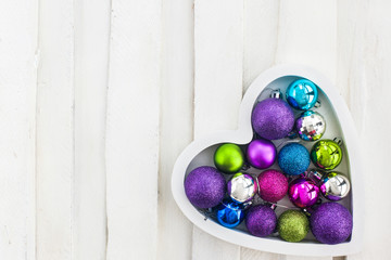 Сhristmas card with wooden heart, balls, decoration and fir-tre