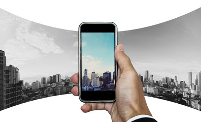 Businessman hand taking panoramic photo of Bangkok cityscape 
