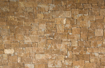 Yellow stone wall background texture 