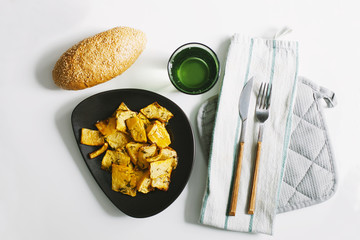 Dish with pumpkin slices and bread on a white background