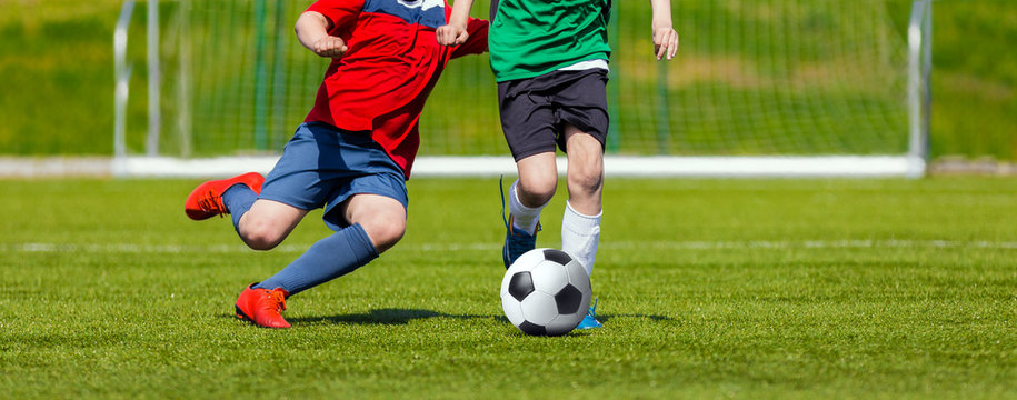Boys kicking soccer ball. Youth soccer game for kids