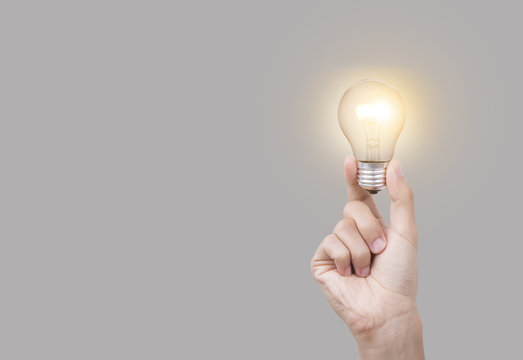 Business hand holding light bulb, concept of new ideas with new innovation and new creativity.