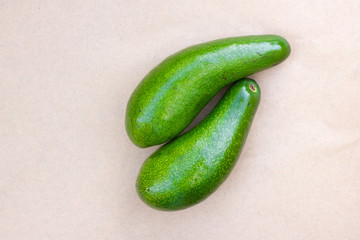 Pair of raw avocados lay on gray background. Yin yang harmony