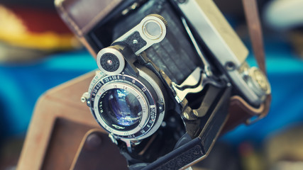 Closeup shot of old retro vintage film photo camera with lens in leather case selective focus