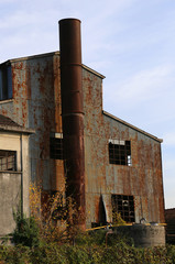 Fototapeta na wymiar big abbandoned factory with high chimney in East Europe