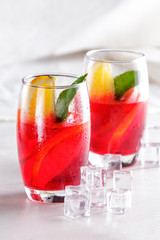 fresh fruit punch with orange slice and ice cube for refreshment
