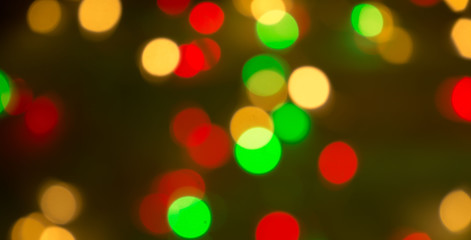 Fototapeta premium Colourful Christmas background of out of focus twinkle lights
