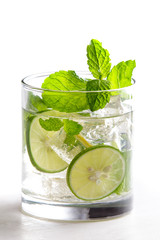 homemade mojito cocktail with fresh limes, mint, and ice