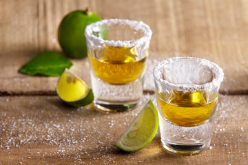 two tequila shots with lime slice and salt