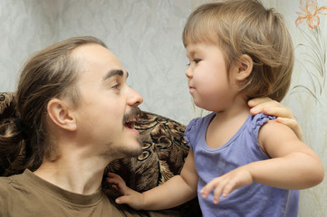 Daddy and little girl communicating actively