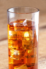 a glass of ice tea with many ice cubes