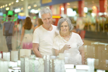Beautiful elderly couple in shopping mall