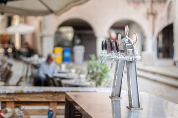 Draught beer taps in a bar.