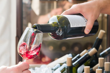 red wine being poured into a glass close-up
