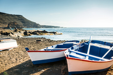 Fototapeta na wymiar painted fishing boats on Canary Island shore in bay