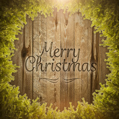 Weihnachtskranz auf rustikalem Holzboden mit Inschrift